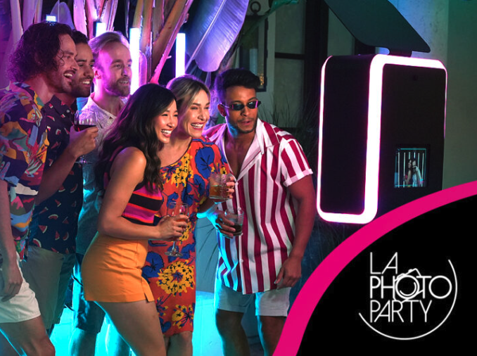 Group of friends taking pictures in a photo booth for a birthday party